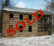Baltimore log cabin with original openings and cantilevered top log.